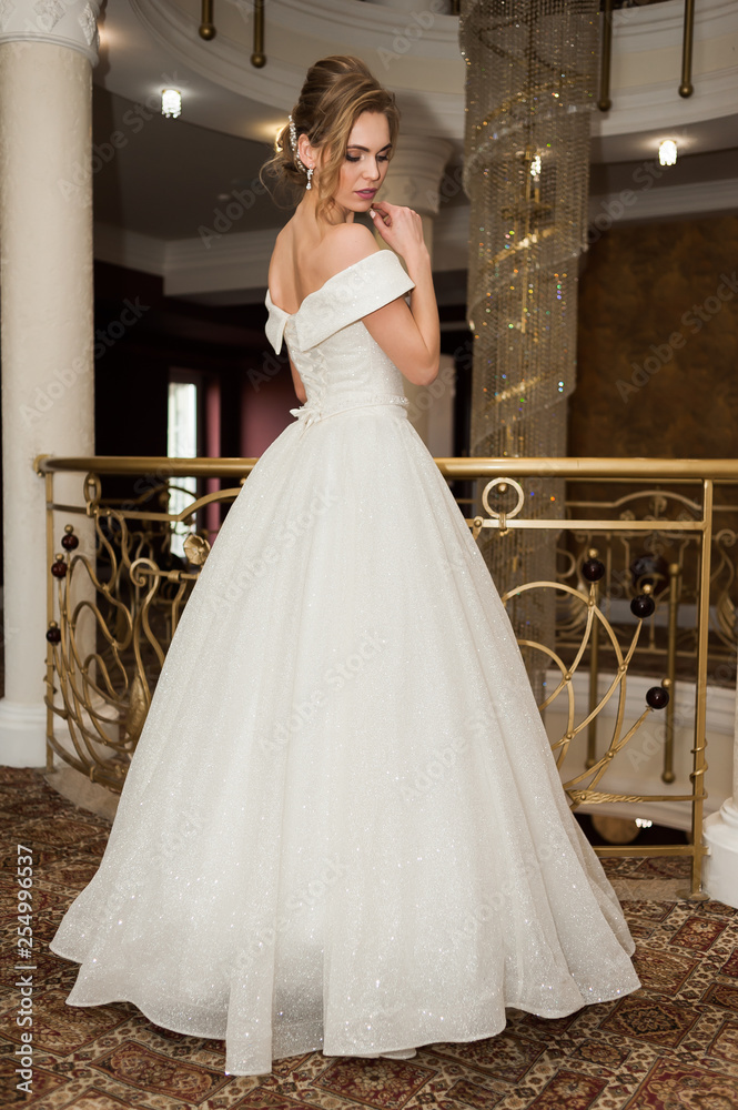 Portrait of a beautiful bride woman in elegant white wedding dress. Luxurious apartments. Portrait of a beautiful bride woman in elegant white wedding dress. Luxurious apartments.