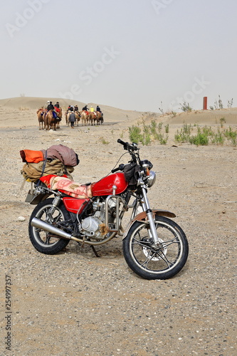 Modern and traditional transportation-motorbike and camels. Rawak Stupa area-Talamakan Desert-China-0015