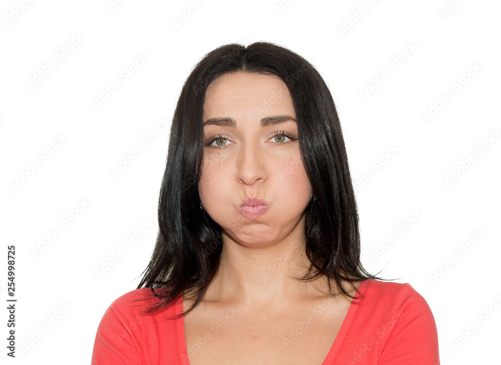 young female blowing her cheeks, frowning, feeling frustrated young female blowing her cheeks, frowning, feeling frustrated