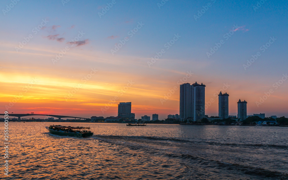 Chao Phraya River at sunset. The river traffic scenery in Bangkok city Evening Chao Phraya River View.