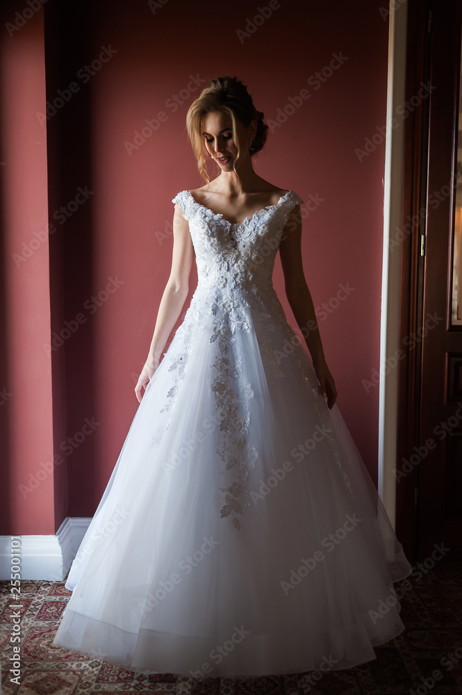 Morning of the bride when she wears a beautiful dress woman getting ready before wedding ceremony Morning of the bride when she wears a beautiful dress woman getting ready before wedding ceremony