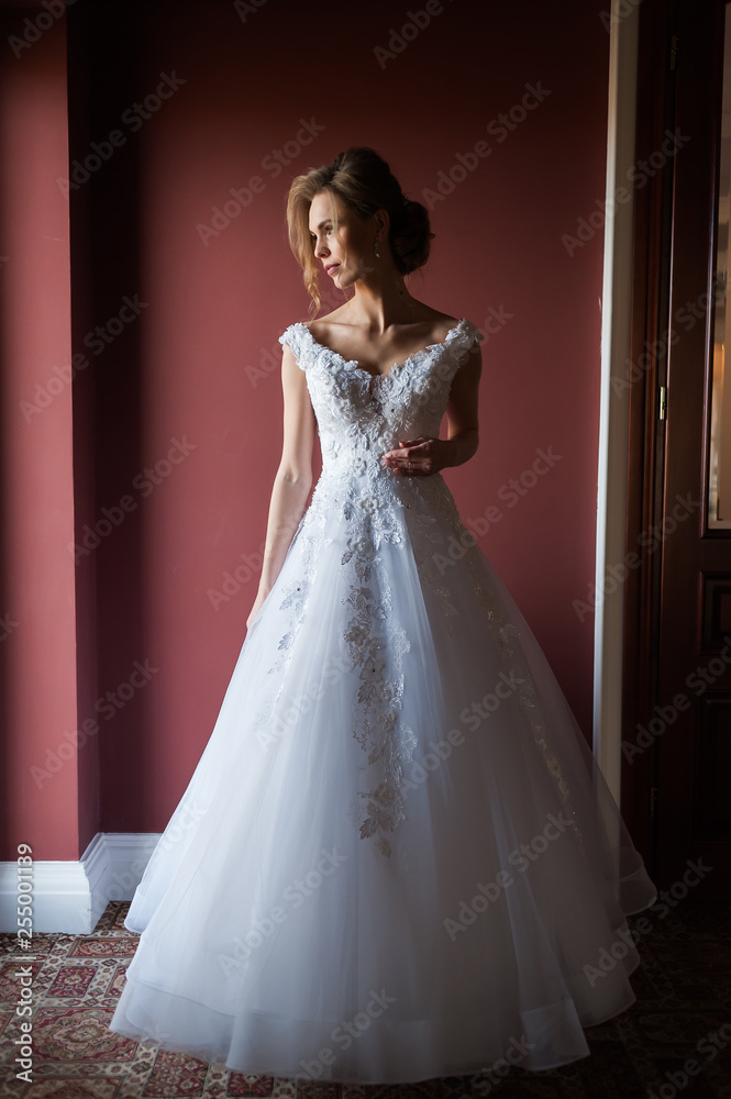 Morning of the bride when she wears a beautiful dress woman getting ready before wedding ceremony Morning of the bride when she wears a beautiful dress woman getting ready before wedding ceremony