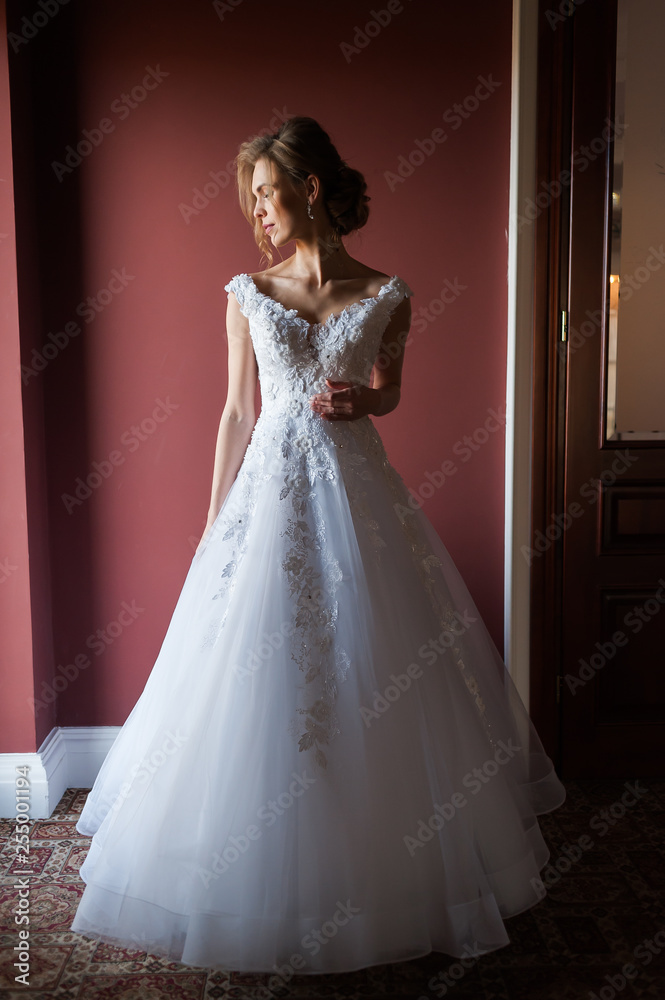 Morning of the bride when she wears a beautiful dress woman getting ready before wedding ceremony Morning of the bride when she wears a beautiful dress woman getting ready before wedding ceremony