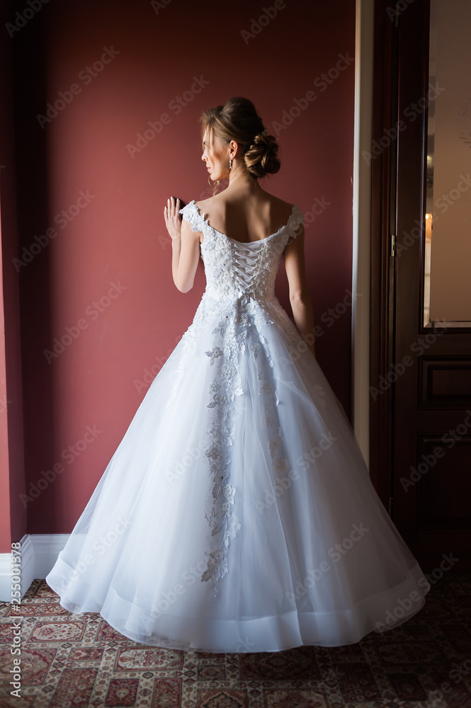 Morning of the bride when she wears a beautiful dress woman getting ready before wedding ceremony Morning of the bride when she wears a beautiful dress woman getting ready before wedding ceremony