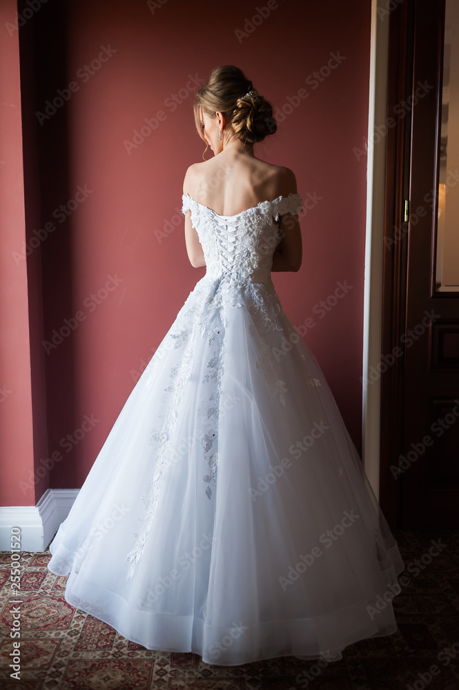 Morning of the bride when she wears a beautiful dress woman getting ready before wedding ceremony Morning of the bride when she wears a beautiful dress woman getting ready before wedding ceremony