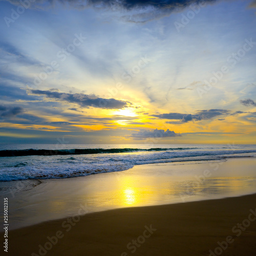 Sunset in ocean  sea waves and sand.