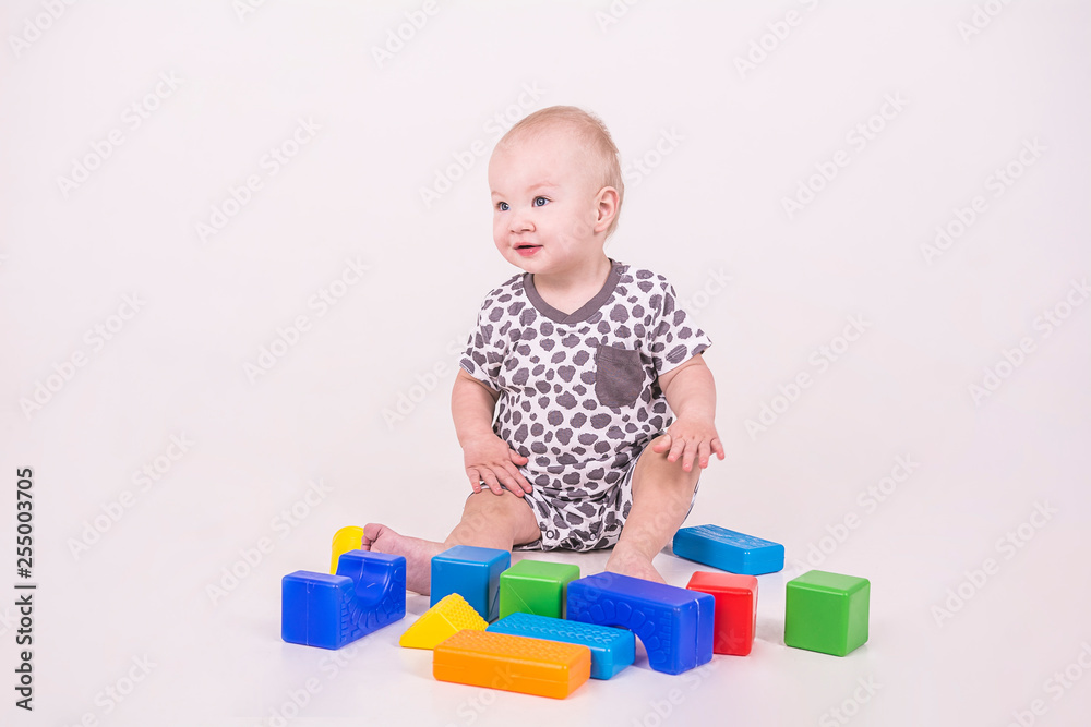 the child plays cubes on a white background the child plays cubes on a white background