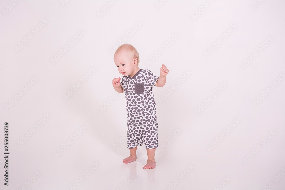 a little baby walks on a white background a little baby walks on a white background