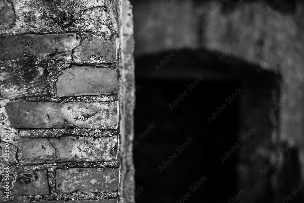looking in darkness behind bricks wall