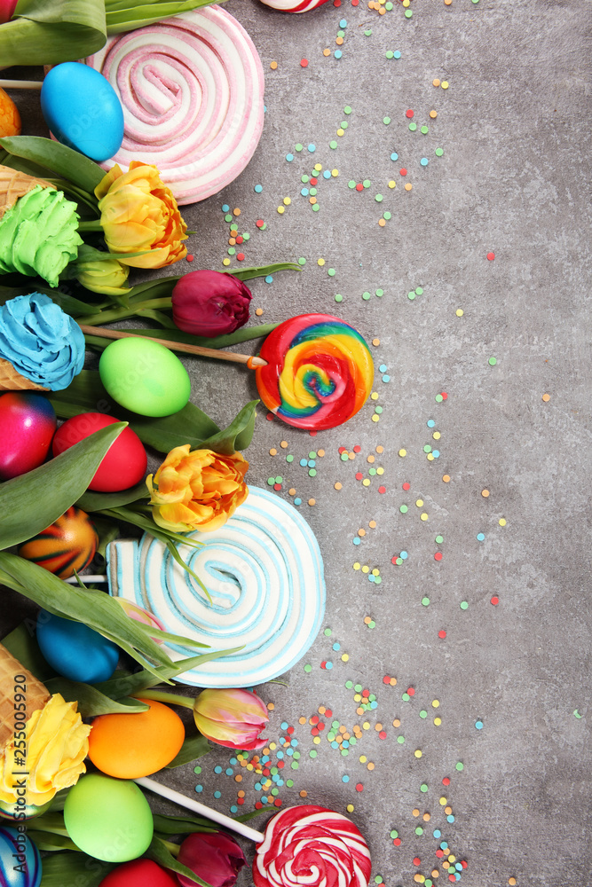 candies with jelly and sugar with tulips and easter eggs.