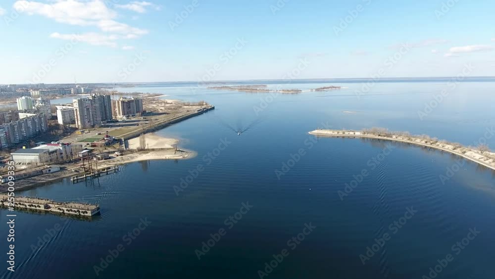 River and cargo port bird's-eye view. Cherkassy city, Ukraine. Panorama. Drone shoots the city and port from the river. River and cargo port bird's-eye view. Cherkassy city, Ukraine. Panorama. Drone shoots the city and port from the river.