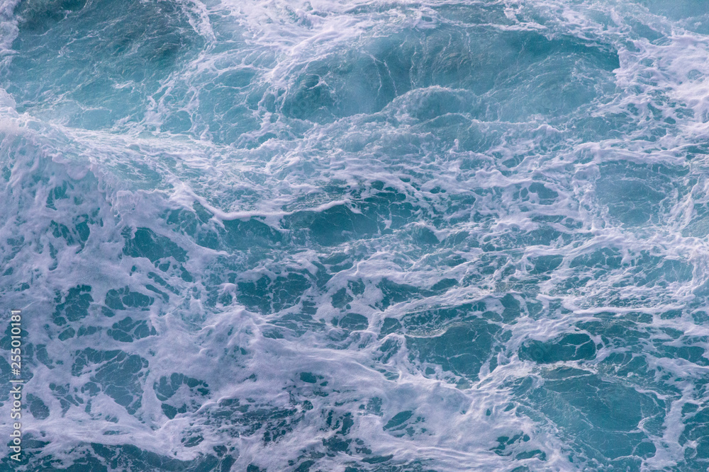 Background of the sea. Waves with foam top view Background of the sea. Waves with foam top view