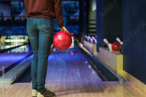 Woman in club for bowling is throwing ball