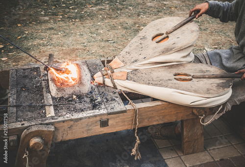 Old woodworking hand tool: wooden plane, chisel ax, sledgehammer, hammer and in a carpentry workshop on dirty rustic table covered with sawdust background side view photo