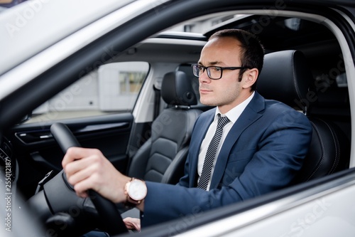 Businessman with glasses driving a car © pantovich