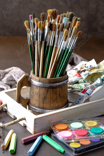 Paint brushes and paints for drawing.