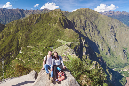 Young couple on Machu Picchu background