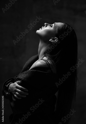 Close up portrait of young beautiful woman with head up posing praying in sexy spring jacket and underwear