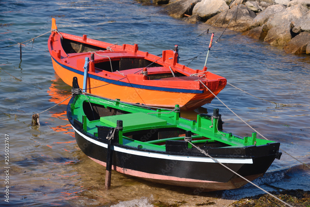 wooden fishing boats moored at the shore