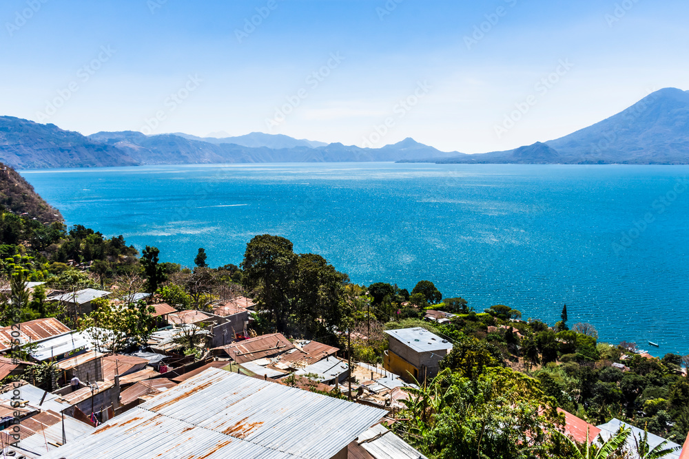 View of rooftops, volcanoes & Lake Atitlan, Guatemala