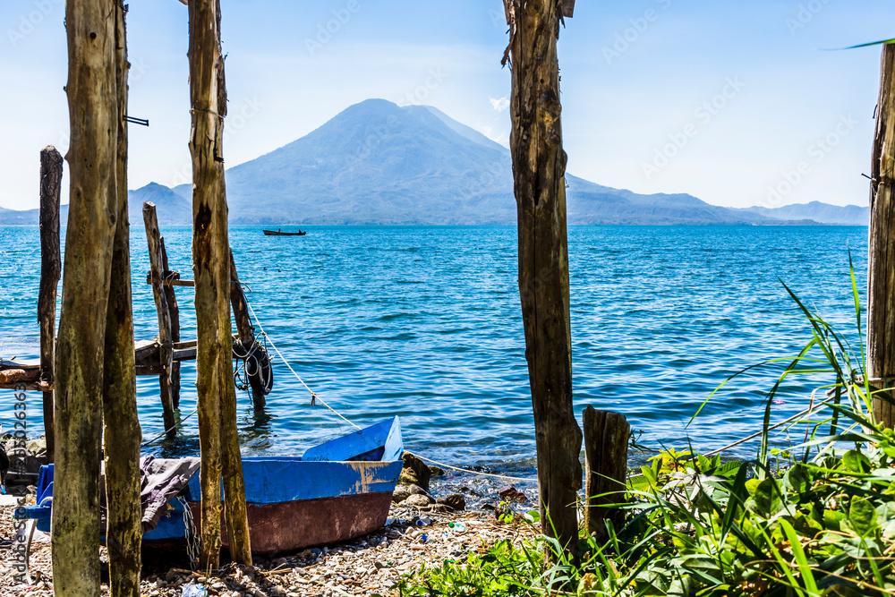 Volcanoes & traditional boat on beach, Lake Atitlan, Guatemala, Central America
