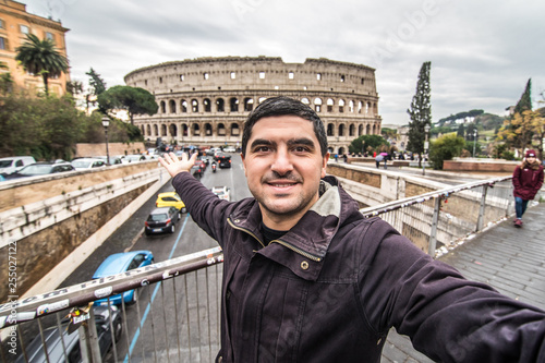 Photography Young pretty man at colosseum taking selfies with smartphone in Rome city centre