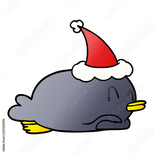 penguin lying on belly wearing santa hat