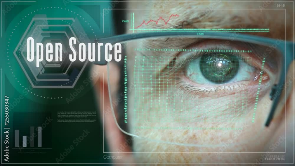 A close up of a businessman eye controlling a futuristic computer system with a Open Source Business concept.