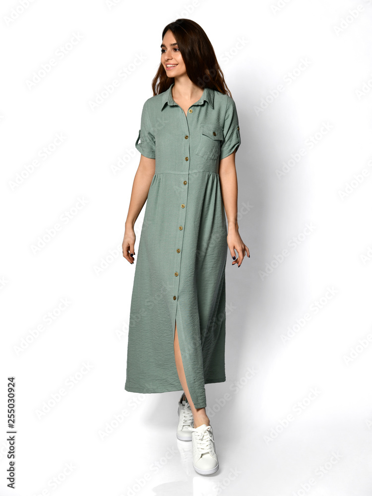 Young beautiful woman posing in new light green fashion dress on high hills full body on a white Young beautiful woman posing in new light green fashion dress on high hills full body on a white