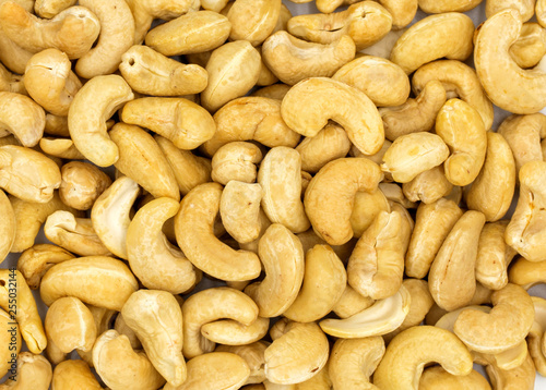 Cashew nuts background, top view photo. Tasty healthy snack. Scattered nut on table. Organic food rustic banner template