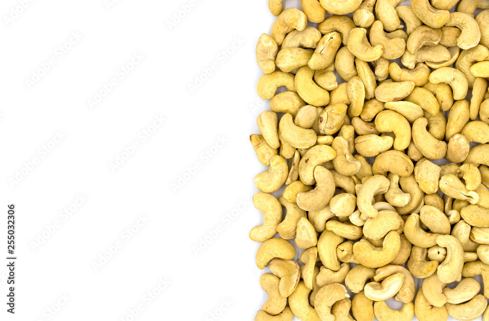 Cashew nut half on white background, top view photo with text place. Scattered nut. Organic food rustic banner template Cashew nut half on white background, top view photo with text place. Scattered nut. Organic food rustic banner template