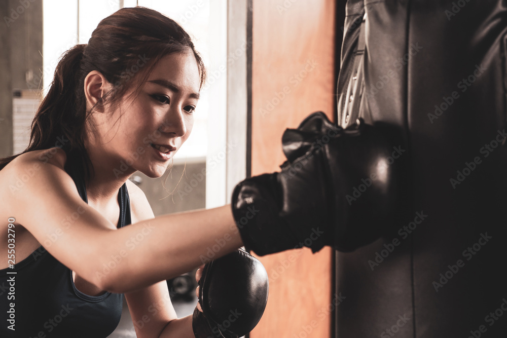 Young athletic girl fighter trains in the gym. Young athletic girl fighter trains in the gym.