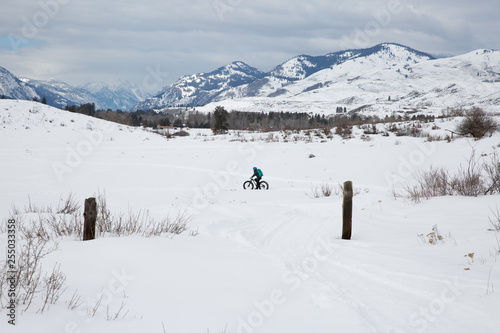 Woman riding fat bike in snowy mountains © meghann