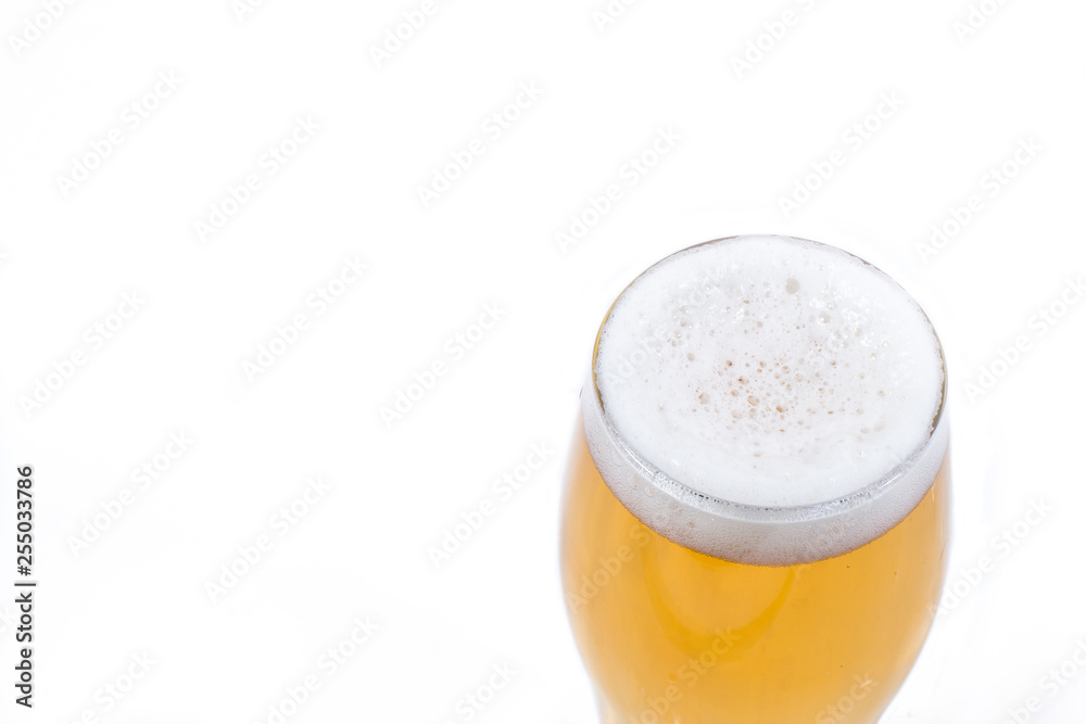 A glass of frothy bubbly beer isolated in white. A glass of frothy bubbly beer isolated in white.