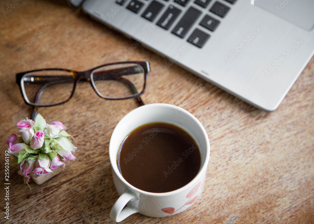 laptop sitting on table with coffee, glasses and plant. good for writer, author or digital nomad concept. laptop sitting on table with coffee, glasses and plant. good for writer, author or digital nomad concept.
