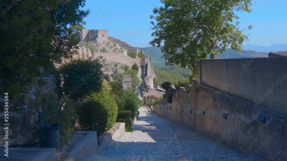 Against the blue sky inside the ancient castle in the wooded mountains of Spain attracts many tourists. Shot in motion Against the blue sky inside the ancient castle in the wooded mountains of Spain attracts many tourists. Shot in motion