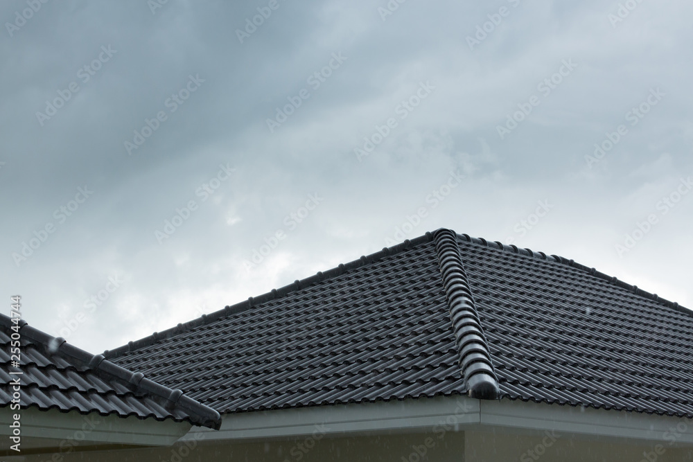 rain storm downpour on black roof tile of residential house rain storm downpour on black roof tile of residential house