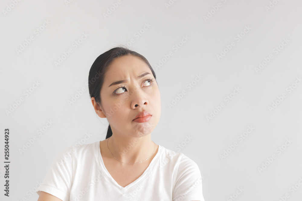 Sulk and grumpy face expression of woman in white t-shirt. Concept of offended peevish and sulky. Sulk and grumpy face expression of woman in white t-shirt. Concept of offended peevish and sulky.