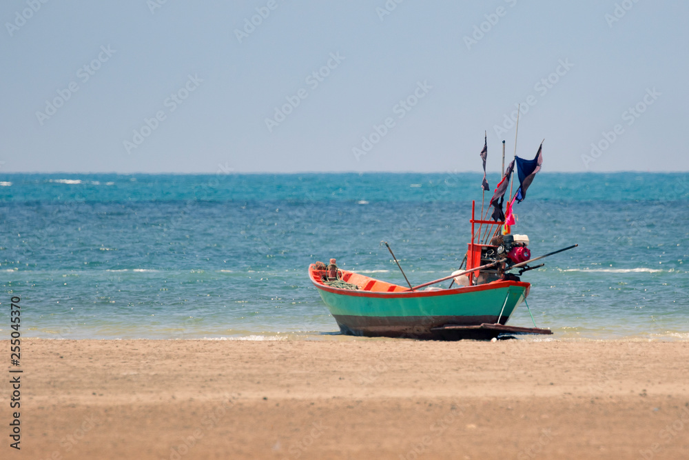 Fototapeta premium Image of small boat sitting on the beach.