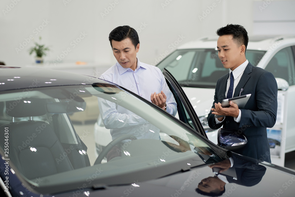 Dealership working taking to client Dealership working taking to client