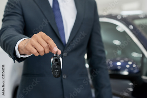 Car seller giving keys