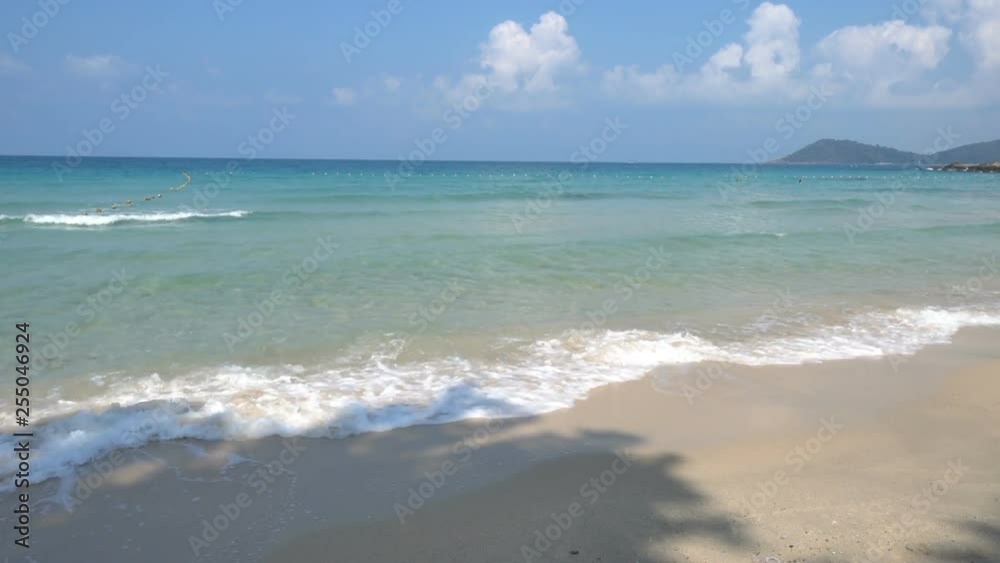 pov locked shot beach to idyllic turquoise calm ocean with slight waves on sandy beach, sunny blue sky day with partial cumulus clouds, mountain jungle landscape on horizon, no people pov locked shot beach to idyllic turquoise calm ocean with slight waves on sandy beach, sunny blue sky day with partial cumulus clouds, mountain jungle landscape on horizon, no people