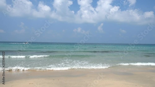 Alluring view of sea view with dense white fluffy clouds on the sky.
Small  jet boat entering the ocean., Waves hitting the shore. photo