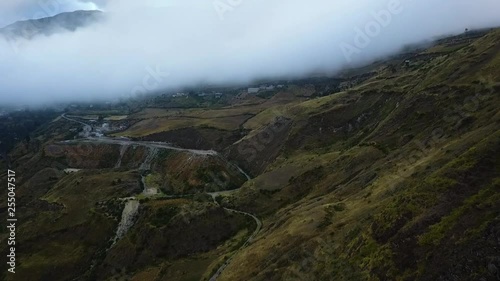Aerial turn revealing roads through the Andes on a cloudy day