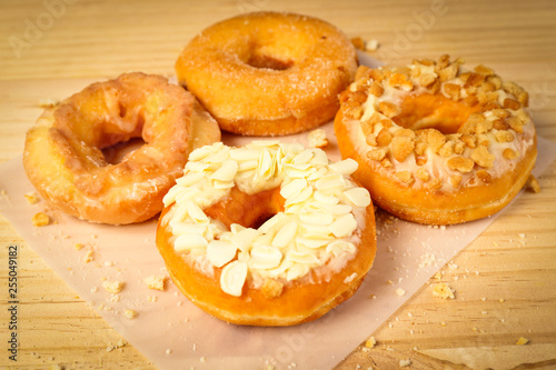 Donuts on wooden background © thechatat