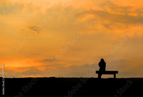 silhouette of woman relax on chair happy time sunset © thechatat