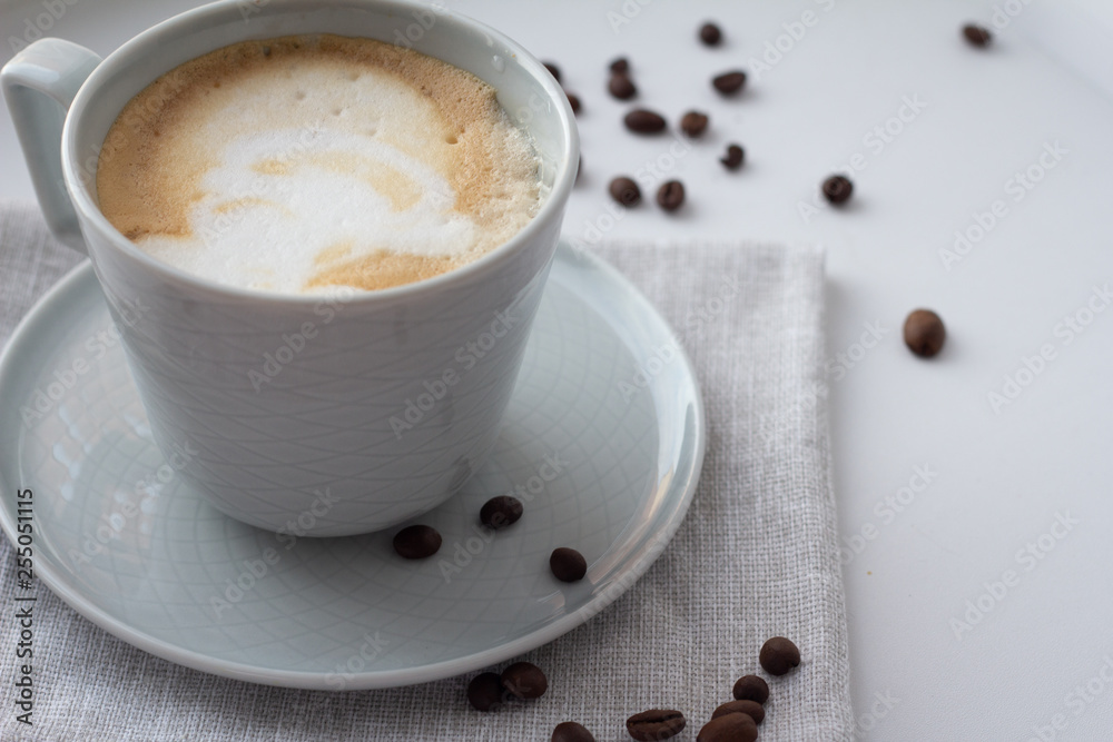 Obraz premium cup of cappuccino coffee on a napkin.