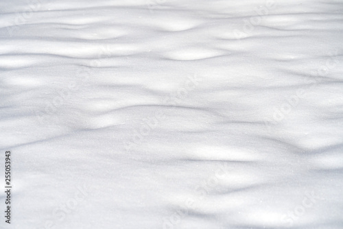 Fototapeta Naklejka Na Ścianę i Meble -  snow drift covered ground texture with shadows