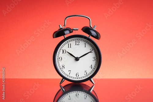 Alarm Clock on red background with selective focus and crop fragment. Business and Copy space concept