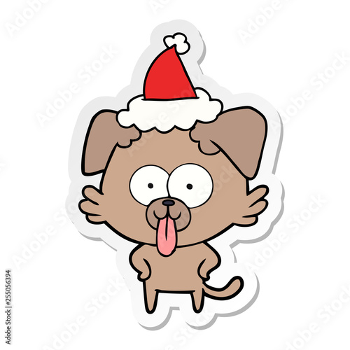 sticker cartoon of a dog with tongue sticking out wearing santa hat © lineartestpilot